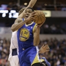 Golden State Warriors guard Kent Bazemore (20) looks to pass after colliding with Dallas Mavericks forward Dirk Nowitzki (41) of Germany during the first quarter of an NBA basketball game Saturday, Feb. 9, 2013, in Dallas. (AP Photo/LM Otero)