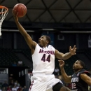 Arizona forward Solomon Hill (44) shoots a layup ahead of San Diego State guard Chase Tapley (22) in the first half of an NCAA college basketball game at the Diamond Head Classic, Tuesday, Dec. 25, 2012, in Honolulu. (AP Photo/Eugene Tanner)