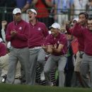 European players celebrate as Ian Poulter makes a putt to win on the 18th hole during a four-ball match at the Ryder Cup PGA golf tournament Saturday, Sept. 29, 2012, at the Medinah Country Club in Medinah, Ill. (AP Photo/Chris Carlson)
