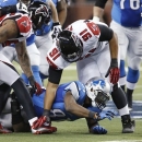 Detroit Lions wide receiver Calvin Johnson fumbles the football, which was recovered Atlanta Falcons cornerback Robert McClain, not seen, during the second quarter of an NFL football game at Ford Field in Detroit, Saturday, Dec. 22, 2012. (AP Photo/Duane Burleson)