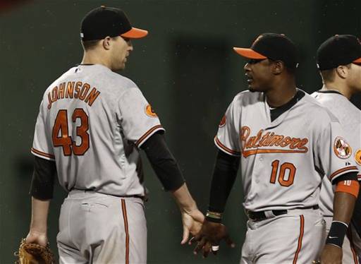 Baltimore Orioles center fielder Adam Jones (10) congratulates relief pitcher Jim Johnson after their 3-2 win against the Boston Red Sox in a baseball game at Fenway Park in Boston, Thursday, April 11, 2013