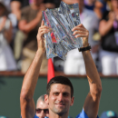 Novak Djokovic, of Serbia, poses with the trophy after his win over Roger Federer, of Switzerland, in the final match at the BNP Paribas Open tennis tournament, Sunday, March 22, 2015, in Indian Wells, Calif. (AP Photo/Mark J. Terrill)