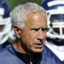 FILE - In this Aug. 2, 2013, file photo Connecticut head coach Paul Pasqualoni walks with his team during NCAA college football practice in Storrs, Conn. Paqualoni was fired Monday, Sept. 30, 2013, after the Huskies lost the first four games of the season. (AP Photo/Jessica Hill, File)