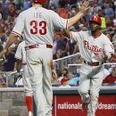Philadelphia Phillies' Jimmy Rollins (11) celebrates with Cliff Lee (33) after Rollins hit a two-run home run in the fourth inning of a baseball game against the Washington Nationals, Tuesday, July 31, 2012, in Washington. (AP Photo/Carolyn Kaster)