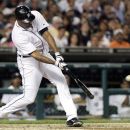Detroit Tigers' Delmon Young hits a three-run home run to score Miguel Cabrera and Omar Infante against the Chicago White Sox and take a 4-1 lead in the sixth inning of a baseball game, Sunday, Sept. 2, 2012, in Detroit. (AP Photo/Duane Burleson)