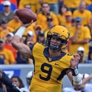 West Virginia quarterback Clint Trickett (9) attempts a pass during the first quarter of an NCAA college football game against Oklahoma Statein Morgantown, W.Va., on Saturday, Sept. 28, 2013. (AP Photo/Tyler Evert)