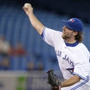 Toronto Blue Jays starter R.A. Dickey pitches to the Tampa Bay Rays during first-inning baseball game action in Toronto, Friday, Sept. 27, 2013. (AP Photo/The Canadian Press, Frank Gunn)