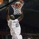 Cincinnati center Cheikh Mbodj (13) dunks in front of Rutgers forward Wally Judge (33) during the first half of an NCAA college basketball game, Wednesday, Jan. 30, 2013, in Cincinnati. (AP Photo/Al Behrman)