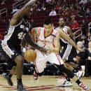 Houston Rockets' Jeremy Lin (7) tries to drives the ball around San Antonio Spurs' DeJuan Blair (45) in the first half of an NBA basketball game, Monday, Dec. 10, 2012, in Houston. (AP Photo/Pat Sullivan)