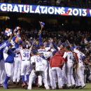 The Dominican Republic players celebrate after beating Puerto Rico in the championship game of the World Baseball Classic in San Francisco, Tuesday, March 19, 2013. The Dominican Republic won 3-0.  (AP Photo/Eric Risberg)