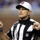 FILE - In this Dec. 24, 2011, file photo, referee Ed Hochuli (85) signals during the second quarter of an NFL football game between the Detroit Lions and the San Diego Chargers in Detroit. The NFL and referees' union reached a tentative agreement on Wednesday, Sept. 26, 2012, to end a three-month lockout that triggered a wave of frustration and anger over replacement officials and threatened to disrupt the rest of the season. (AP Photo/Carlos Osorio, File)
