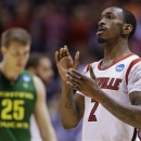 Louisville guard Russ Smith (2) reacts after his team's 77-69 win over Oregon in a regional semifinal against Oregon in the NCAA college basketball tournament, Friday, March 29, 2013, in Indianapolis. At left is Oregon's E.J. Singler (25). (AP Photo/Michael Conroy)