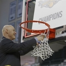 Green Bay's head coach Kevin Borseth cuts down the net while celebrating Green Bay's win over Loyola in the Horizon League Women's Basketball Championship game on Sunday March 17, 2013 at the Kress Events Center in Green Bay, Wis. Green Bay won 54-38 (AP Photo/Matt Ludtke)