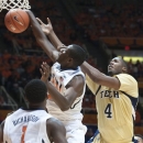 Illinois' Nnanna Egwu (32) rejects the shot by Georgia Tech Robert Carter, Jr. (4) during the first half of an NCAA college basketball game in Champaign, IL. Wednesday, Nov. 28, 2012. (AP Photo/Robert K. O'Daniell)
