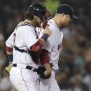 Boston Red Sox starting pitcher Jon Lester walks back to the mound with catcher Jarrod Saltalamacchia after an apparent injury while throwing during the eighth inning of a baseball game against the Toronto Blue Jays at Fenway Park, Thursday, June 27, 2013, in Boston. (AP Photo/Charles Krupa)