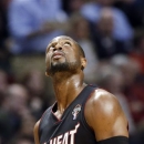 Miami Heat guard Dwyane Wade looks up at a scoreboard after he was called for a foul on Chicago Bulls guard Jimmy Butler during the first half of an NBA basketball game in Chicago on Wednesday, March 27, 2013. (AP Photo/Nam Y. Huh)