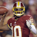 FILE - In this Jan. 6, 2013, file photo, Washington Redskins quarterback Robert Griffin III passes the ball during the second half of an NFL wild card playoff football game against the Seattle Seahawks in Landover, Md. Griffin has won The Associated Press 2012 NFL Offensive Rookie of the Year award, beating out two other sensational first-year quarterbacks, it was announced on Saturday, Feb. 2, 1013. (AP Photo/Matt Slocum, File)