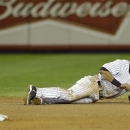 New York Yankees shortstop Derek Jeter reacts after injuring himself in the 12th inning of Game 1 of the American League championship series against the Detroit Tigers early Sunday, Oct. 14, 2012, in New York. (AP Photo/Paul Sancya )