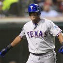 Texas Rangers' Adrian Beltre smiles after scoring on a single by Michael Young in the seventh inning of a baseball game against the Cleveland Indians, Friday, Aug. 31, 2012, in Cleveland. (AP Photo/Tony Dejak)