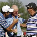 David Frost, left, and Bobby Clampett, right, celebrate with Roger Chapman after his win in the Senior PGA Championship golf tournament at Harbor Shores Golf Club in Benton Harbor, Mich., Sunday, May 27, 2012. (AP Photo/Carlos Osorio)