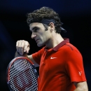 Switzerland's Roger Federer walks towards the net at match point after defeating Britain's Andy Murray during their singles ATP World Tour Finals tennis match at the O2 Arena in London, Thursday, Nov. 13, 2014. (AP Photo/Kirsty Wigglesworth)