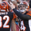 Cincinnati Bengals quarterback Andy Dalton (14) congratulates wide receiver Marvin Jones (82) after they combined on their third touchdown pass of the game in the first half of an NFL football game against the New York Jets, Sunday, Oct. 27, 2013, in Cincinnati. (AP Photo/David Kohl)