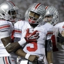 Ohio State quarterback Braxton Miller (5) celebrates his touchdown with teammates Michael Thomas, left, and Corey Linsley, right rear, during the third quarter of an NCAA college football game against Penn State in State College, Pa., Saturday, Oct. 27, 2012. (AP Photo/Gene J. Puskar)