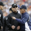 First base umpire Jeff Kellogg, center, stands between home plate umpire Chad Fairchild, left, and Detroit Tigers manager Jim Leyland as Leyland argues the ejection of Miguel Cabrera in the third inning of an MLB baseball game against the Philadelphia Phillies in Detroit, Sunday, July 28, 2013. (AP Photo/Carlos Osorio)