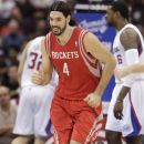 In this March 17, 2012, photo, Houston Rockets' Luis Scola, of Argentina, runs up the court during an NBA basketball game against the Los Angeles Clippers in Los Angeles. The Rockets waived Scola on Friday, July 13, 2012, clearing more salary space with a major move in mind. A fan favorite in Houston, the 6-foot-9 Scola averaged 14.5 points and 7.7 rebounds in five seasons with the Rockets. Scola grabbed 2,984 rebounds with the Rockets to rank ninth on the team's career list. (AP Photo/Jae C. Hong)