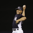 New York Yankees relief pitcher Mariano Rivera winds up for a warm-up pitch in the sixth inning of a spring training baseball game against the Houston Astros in Tampa, Fla., Tuesday, March 26, 2013.  (AP Photo/Kathy Willens)