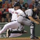 Boston Red Sox's Adrian Gonzalez slides safely into home to score on a double by David Ortiz as Detroit Tigers catcher Alex Avila waits for the throw during the fifth inning of a baseball game at Fenway Park in Boston on Tuesday, May 29, 2012. (AP Photo/Elise Amendola)