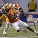 Clemson quarterback Tajh Boyd (10) is tackled by LSU defensive tackle Bennie Logan (18) during the second half of the Chick-fil-A Bowl NCAA college football game, Monday, Dec. 31, 2012, in Atlanta. (AP Photo/David Goldman)