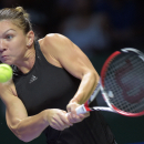 Simona Halep of Romania returns a shot against Eugenie Bouchard of Canada during their singles match at the WTA tennis finals in Singapore, Monday, Oct. 20, 2014. (AP Photo/Joseph Nair)