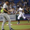 Detroit Tigers starting pitcher Justin Verlander, left, walks back to the mound as Tampa Bay Rays' Desmond Jennings rounds third base after hitting his second home run of the night during the fifth inning of a baseball game in St. Petersburg, Fla., Friday, June 29, 2012. (AP Photo/Phelan M. Ebenhack)