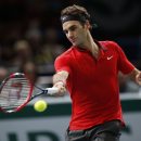 Roger Federer of Switzerland returns the ball to Milos Raonic of Canada during their quarterfinal match at the ATP World Tour Masters tennis tournament at Bercy stadium in Paris, France, Friday, Oct. 31, 2014. Raonic won 7-6, 7-5. (AP Photo/Michel Euler)