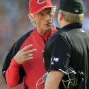 Cincinnati Reds acting manager Chris Speier, left, questions a call with home plate umpire Mike Muchlinski during a baseball game against the Los Angeles Dodgers, Saturday, Sept. 22, 2012, in Cincinnati. Reds manager Dusty Baker remained in a Chicago hospital after experiencing an irregular heartbeat. (AP Photo/Al Behrman)