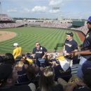 Josh Cribbs, right, of the Cleveland Browns NFL football team, arrives at TD Ameritrade Park to help cheer on Kent State in their NCAA College World Series baseball game against Arkansas, in Omaha, Neb., Saturday, June 16, 2012. Cribbs joined a busload of 
