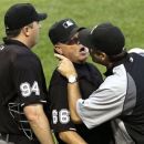 Umpire crew chief Jim Joyce, center, keeps Chicago White Sox manager Robin Ventura, right, away from home plate umpire Lance Barrett after Barrett ejected catcher A.J. Pierzynski and Ventura during the third inning of a baseball game against the Seattle Mariners, Saturday, Aug. 25, 2012, in Chicago. (AP Photo/Charles Rex Arbogast)
