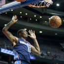 Charlotte Bobcats forward Tyrus Thomas watches his dunked ball during the first half of an NBA preseason basketball game against the Detroit Pistons on Saturday, Oct. 20, 2012, in Auburn Hills, Mich. (AP Photo/Duane Burleson)
