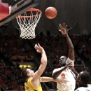 Illinois' Sam McLaurin (0) shoots over Michigan's Mitch McGary (4) during the first half of an NCAA college basketball game, Sunday, Jan. 27, 2013, in Champaign, Ill. (AP Photo/John Dixon)