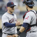 Cleveland Indians pitcher Joe Smith, left, and catcher Yan Gomes celebrate as the Indians beat the Minnesota Twins 5-1 in a baseball game, Saturday, Sept. 28, 2013, in Minneapolis. (AP Photo/Jim Mone)