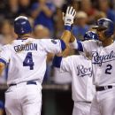 Kansas City Royals' Alex Gordon (4) is congratulated by teammate Alcides Escobar (2) following his two-run home run during the fifth inning of a baseball game against the Texas Rangers at Kauffman Stadium in Kansas City, Mo., Tuesday, Sept. 4, 2012. (AP Photo/Orlin Wagner)