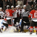A scuffle breaks out between the Chicago Blackhawks and the Colorado Avalanche in front of the Avalanche bench during the first period of an NHL hockey game, Wednesday, March 6, 2013, in Chicago. (AP Photo/Charles Rex Arbogast)