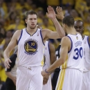 Golden State Warriors forward David Lee, left, celebrates after scoring with teammate Seth Curry, right, during the second quarter of Game 3 of a Western Conference semifinal NBA basketball playoff series against the San Antonio Spurs in Oakland, Calif., Friday, May 10, 2013. (AP Photo/Jeff Chiu)