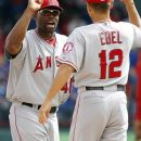 Los Angeles Angels right fielder Torii Hunter (48) celebrates their 5-4 win over the Texas Rangers with third base coach Dino Ebel (12) after the final out of the first baseball game of a doubleheader, Sunday, Sept. 30, 2012, in Arlington, Texas. (AP Photo/LM Otero)