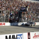 Jimmie Johnson takes the checkered flag to win a NASCAR Sprint Cup Series auto race on Sunday, Sept. 29, 2013, at Dover International Speedway in Dover, Del. (AP Photo/Nick Wass)