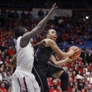 Washington's Perris Blackwell, right, looks to pass the ball around Arizona's Angelo Chol during the first half of an NCAA college basketball game at McKale Center in Tucson, Ariz., Wednesday, Feb. 20, 2013. (AP Photo/Wily Low)