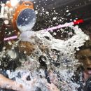 Washington Nationals first baseman Adam LaRoche (25) is doused as he is interviewed by a television reporter, right, during the Nationals' celebration after clutching the National League East division title following their baseball game against the Philadelphia Phillies in Washington, Monday, Oct. 1, 2012. (AP Photo/Manuel Balce Ceneta)