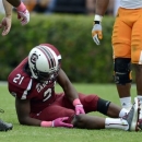 South Carolina running back Marcus Lattimore grabs his right knee after getting hit by Tennessee's Eric Gordon during the first half of an NCAA college football game Saturday, Oct. 27, 2012 at Williams-Brice Stadium in Columbia, S.C. (AP Photo/Richard Shiro)