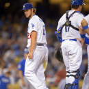 Los Angeles Dodgers starting pitcher Clayton Kershaw, left, looks back while he is taken out of the game as catcher A.J. Ellis looks on during the sixth inning of their baseball game against the Chicago Cubs, Tuesday, Aug. 27, 2013, in Los Angeles. (AP Photo/Mark J. Terrill)